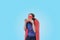Woman superhero is eating pizza with a red cape, blue.