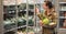 Woman in the supermarket. Beautiful young woman holds in hands fresh organic vegetables and opens the fridge in the supermarket