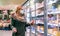 Woman at supermarket freezer section wearing face mask