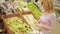 A woman in a supermarket on a vegetable shelf, buying vegetables, Zucchini