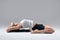 Woman in supta virasana yoga position