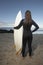 Woman With Surfboard Standing On Beach