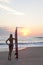 Woman Surfer In Bikini & Surfboard At Sunset Beach