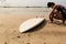 Woman surfer ready to surf on a beach