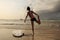 Woman surfer warming up on the beach