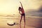 Woman surfer warming up on beach