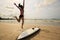 Woman surfer warming up on beach