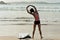 Woman surfer warming up on beach