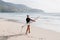 Woman with surfing board on the beach