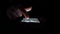 Woman surfs internet using modern smartphone. Close up. Black background