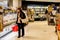 A woman surveying deli aisle at Coles Supermarket