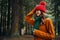 woman in sweater and caps are walking in nature in the forest in autumn cropped view