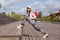 A woman in sweatshirt on the bridge stretches before training