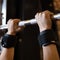 Woman sweaty hands, execute exercise on horizontal bar in gym