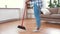 Woman with sweeping broom brush cleaning floor