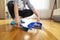 Woman sweeping floor and collecting dust onto a dustpan