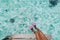 Woman swim feet snorkeler playful having fun with pink snorkel fins over ocean beach. Legs closeup of swimmer relaxing