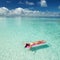 Woman swim and relax in the sea. Happy island lifestyle. White sand, crystal-blue sea of tropical beach. Vacation at Paradise.