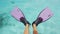 Woman swim snorkel feet playful having fun with pink fins over ocean beach