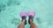 Woman swim snorkel feet playful having fun with pink fins over ocean beach