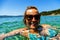 Woman swiming in the sea on tropical island, smiling at camera w