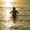 Woman swimmer silhouette at sunset