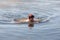 Woman swimming in cold spring water