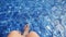 Woman in swimming pool enjoys vacation splashing feet in fresh clear water in slow motion. 1920x1080