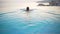 Woman In Swimming Pool Spa Enjoying Sunset On Over Sea Luxury Vacation Travel in Greece, Europe. Girl in bikini watching