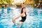 Woman in swimming pool on summer vacation. Summertime, girl with luxury lifestyle in bikini fashion. Girl having fu