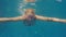 A woman is swimming in the pool. Underwater video