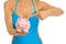 Woman in swimsuit pointing on piggy bank. Closeup