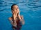 woman in swimsuit in the pool outdoors closed eyes luxury leisure