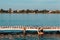 woman in swimsuit at wooden pier. resting at lake