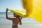 Woman in swimwear waving yellow scarf on the beach