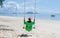 A woman on a swing on the beach in Phuket Thailand, women on a tropical beach in Thailand