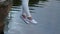 Woman swinging legs over ripples lake water