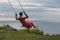 Woman swinging on a swing on a tropical island