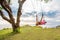 Woman swinging on a swing on a tropical island