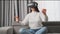 Woman swipes virtual interface looking through VR glasses
