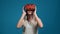 Woman in t-shirt puts on virtual reality headset to play