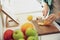 Woman with tablet cooking at table in kitchen