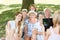 Woman with tablet takes picture of extended family