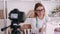 A woman tailor is filming a sewing tutorial with a camera