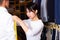 Woman tailor makes measurements of customer clothes in s