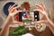 Woman take a picture of different beautiful vegetables and greens with a mobile phone at her kitchen. Smartphone food