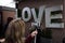 Woman take a picture of love inscription with her smartphone