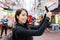 Woman take selfie in Hong Kong temple street