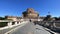 A woman taken from behind carries the stroller in front of Castel Sant`Angelo in Rome during the coronavirus pandemic