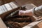 Woman takes from the box pieces of chewed treats for the dogs. I